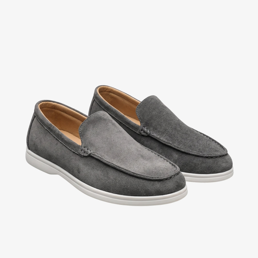 Men's suede slip-on style loafers with a white sole
