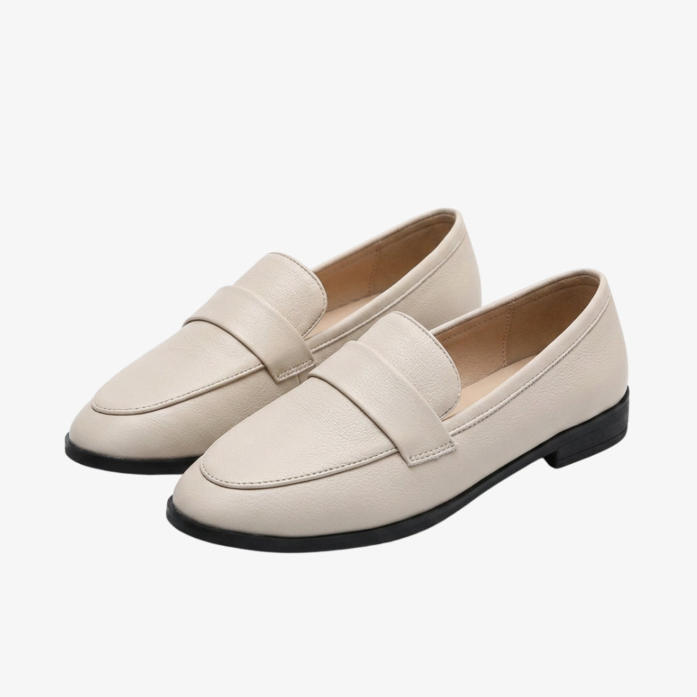 Elegant minimalist white faux leather loafer on a gray background