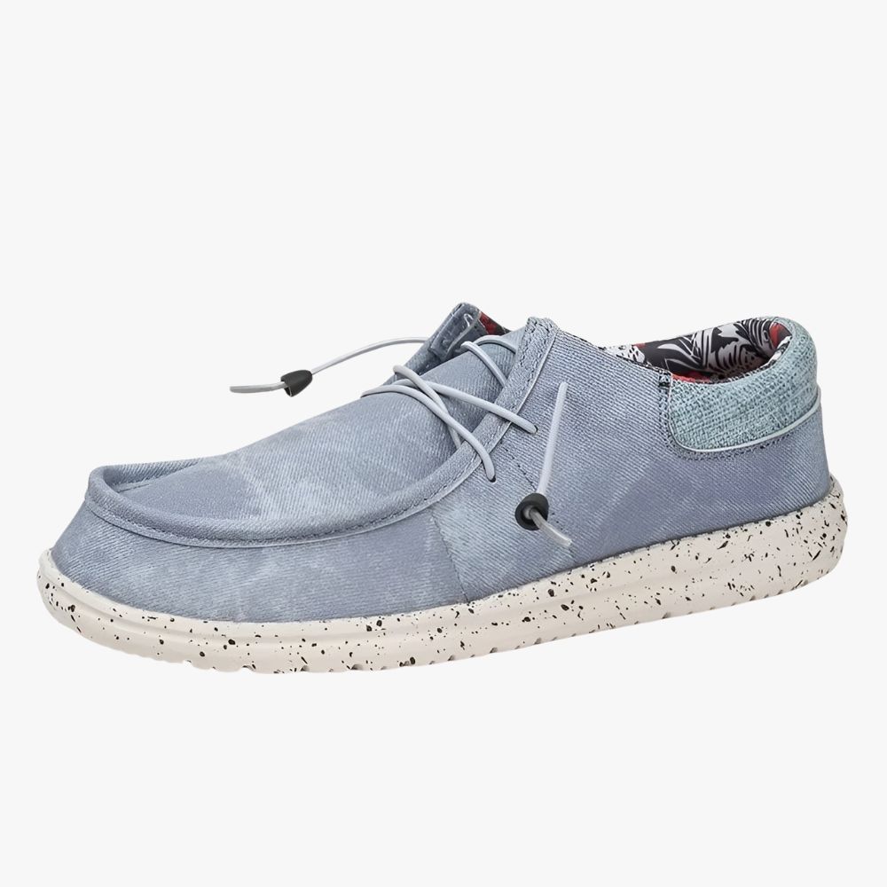 Blue fabric loafers with white soles. The inner lining is a floral fabric.