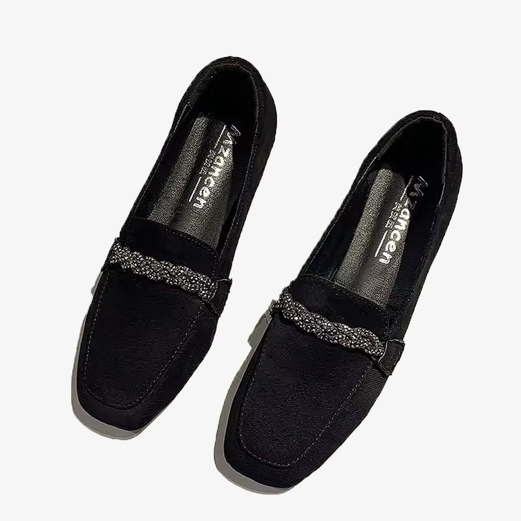 Elegant suede loafers with rhinestone chains on a white background