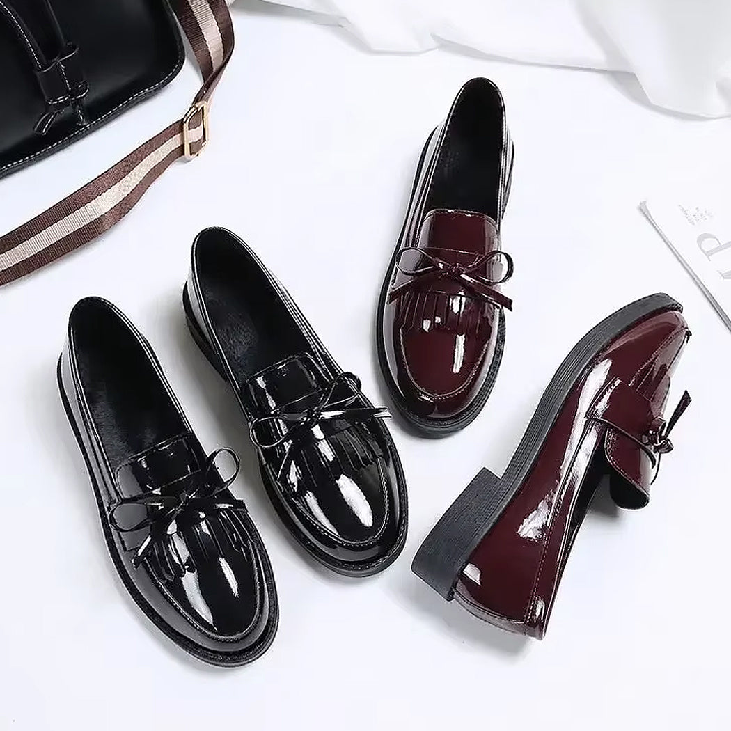 Patent loafers with fringe and bow