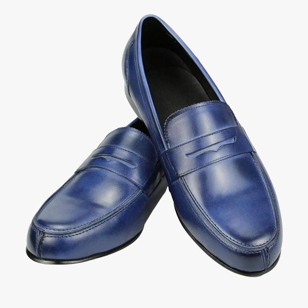 A pair of men's blue genuine leather loafers on a white background