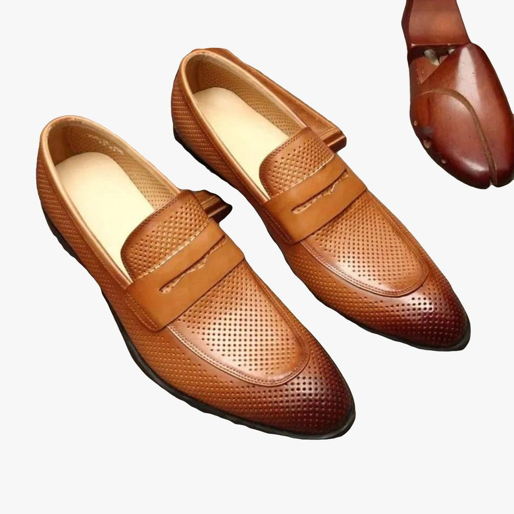 A pair of brown pointed-toe genuine leather loafers for men on a gray background