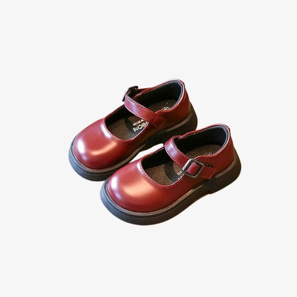 Pair of classic leather-look loafers for girls with strap.