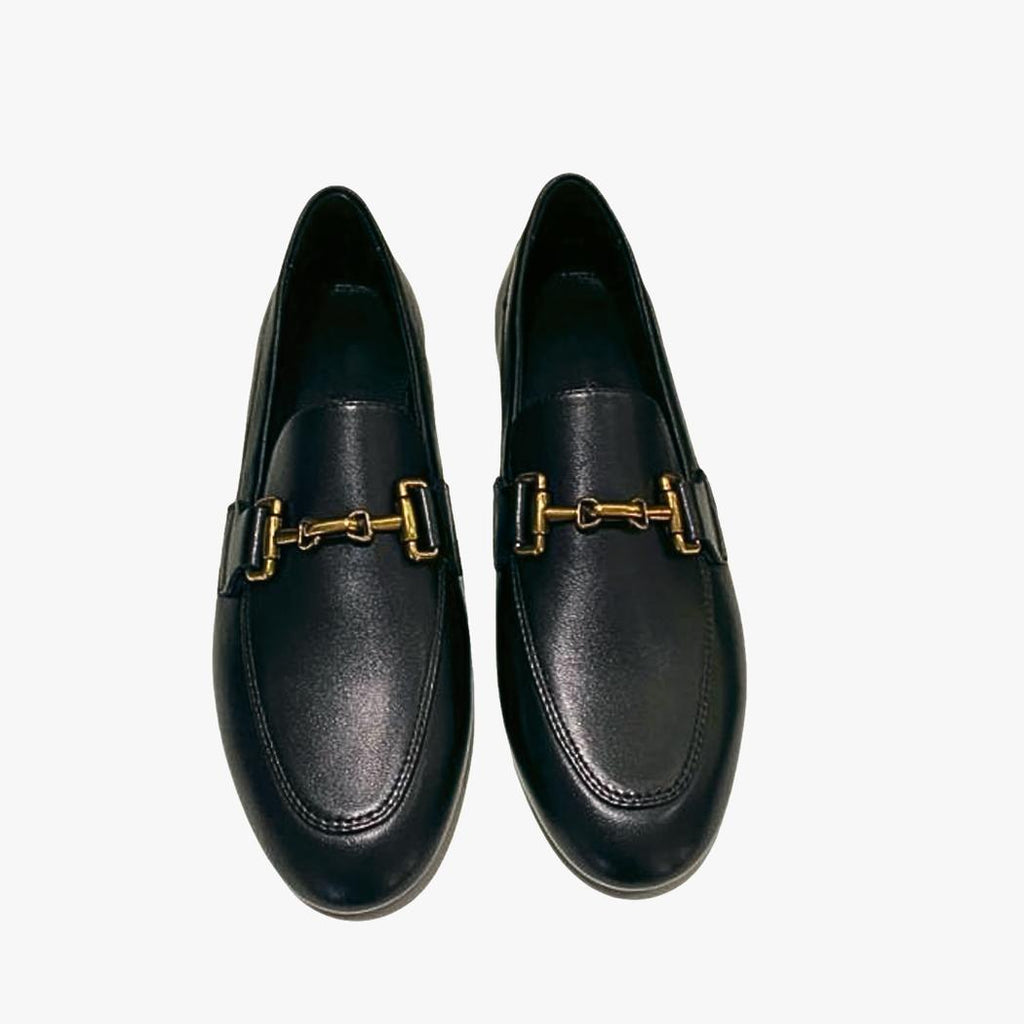 A pair of women's black genuine leather loafers on a white background