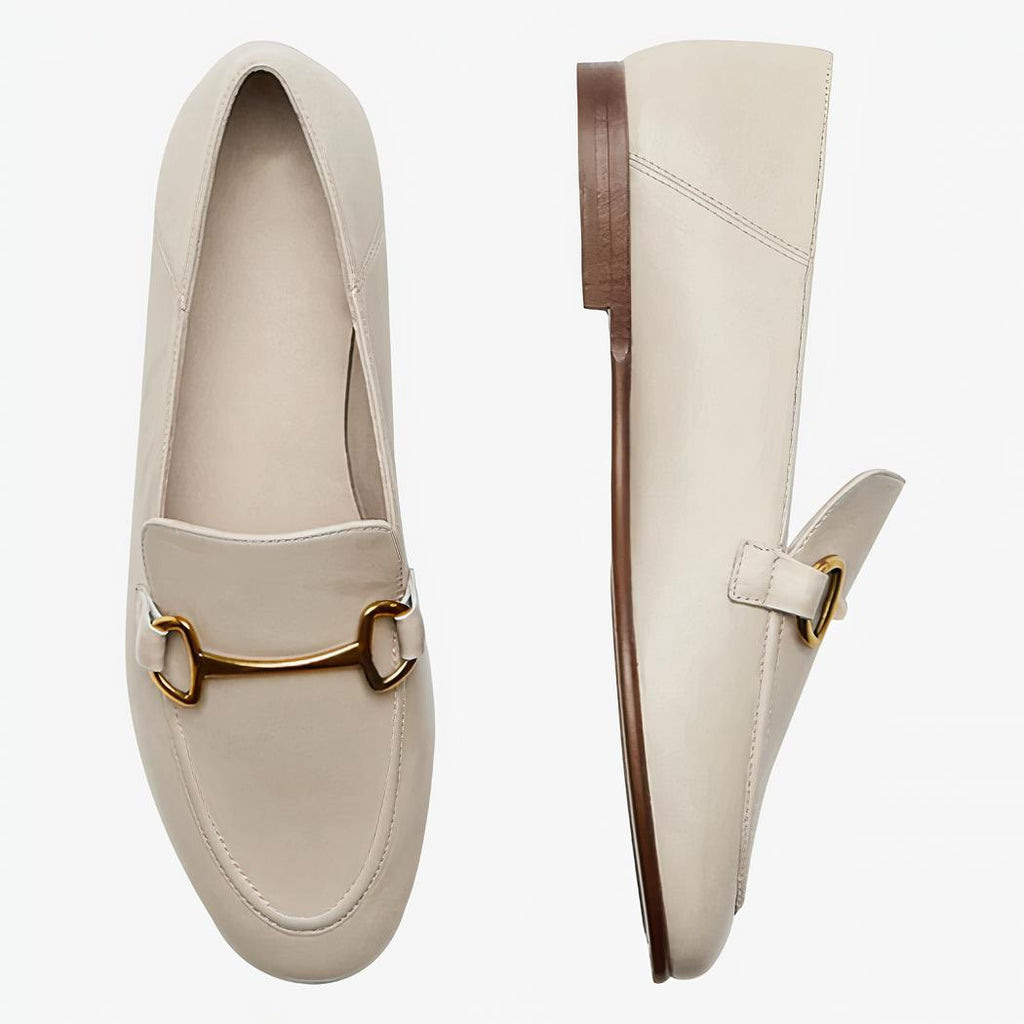 A pair of thin, lightweight beige genuine leather loafers on a light background