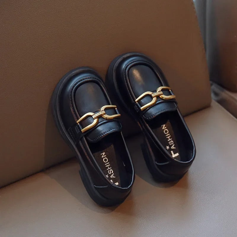 Girls' dark loafers with a polished metal buckle