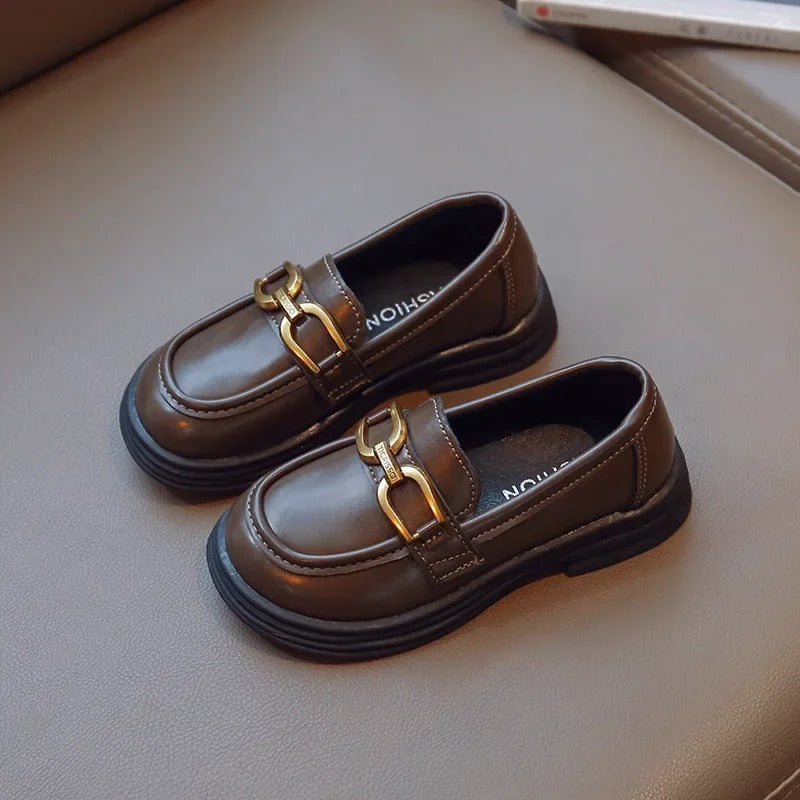 Girls' dark loafers with a polished metal buckle