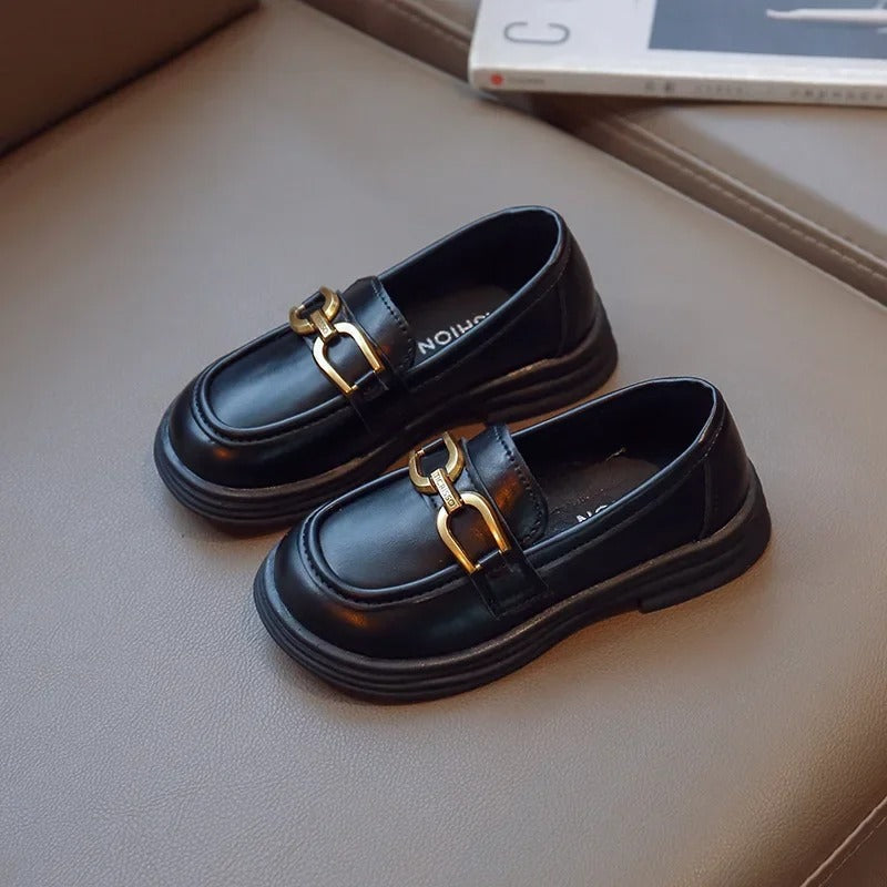 Girls' dark loafers with a polished metal buckle