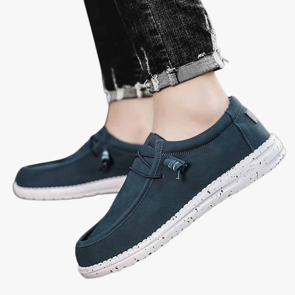 Blue faux leather loafers with a white sole and small black spots