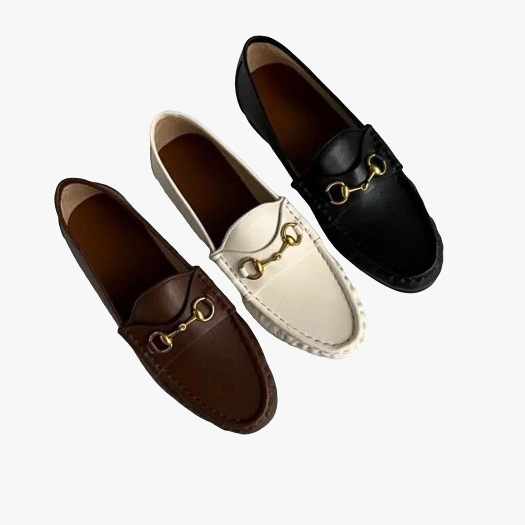 On a light gray background, 3 soft genuine leather loafers for women, one white, one brown and one black.