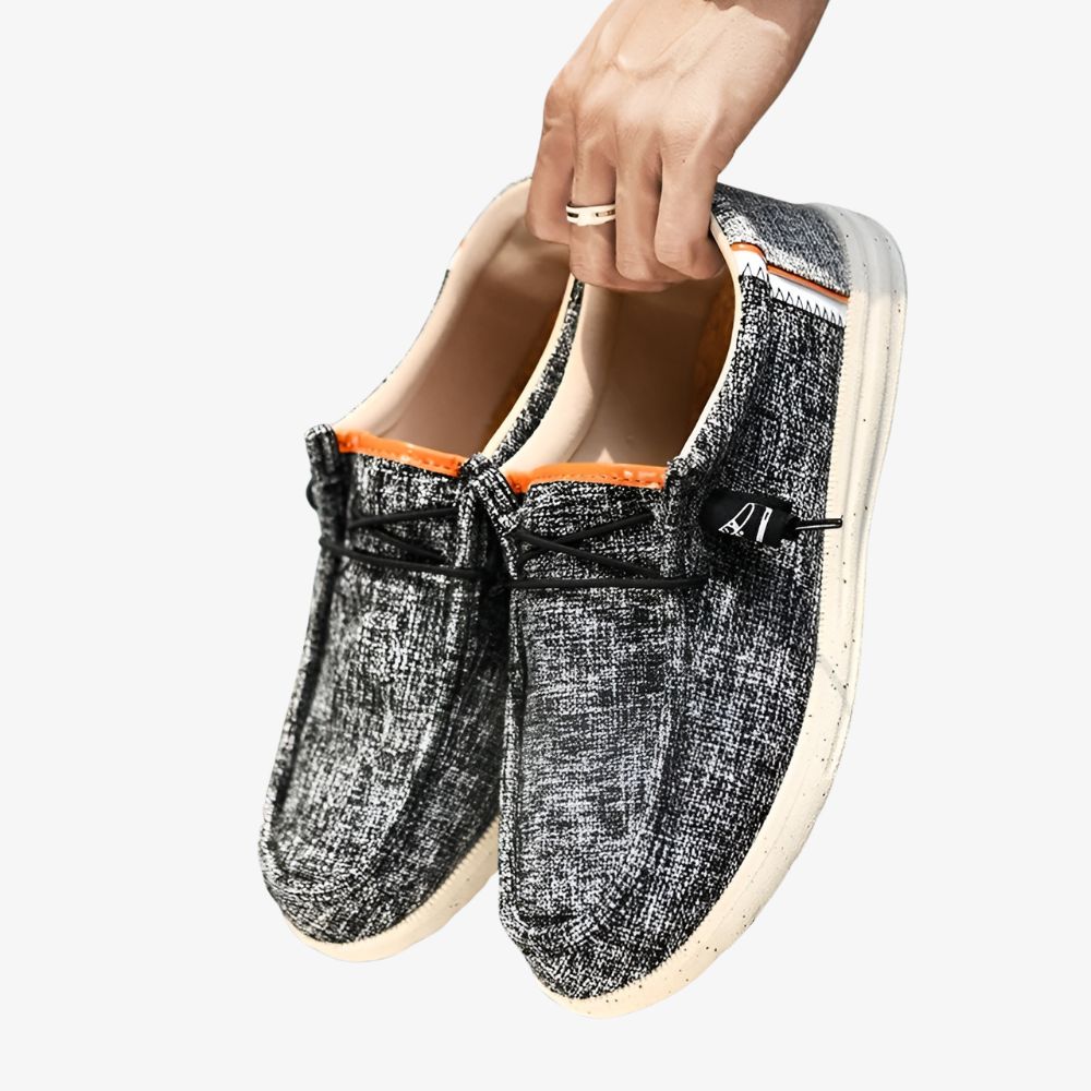 Pair of men's canvas loafers in gray with small black specks and a white sole.