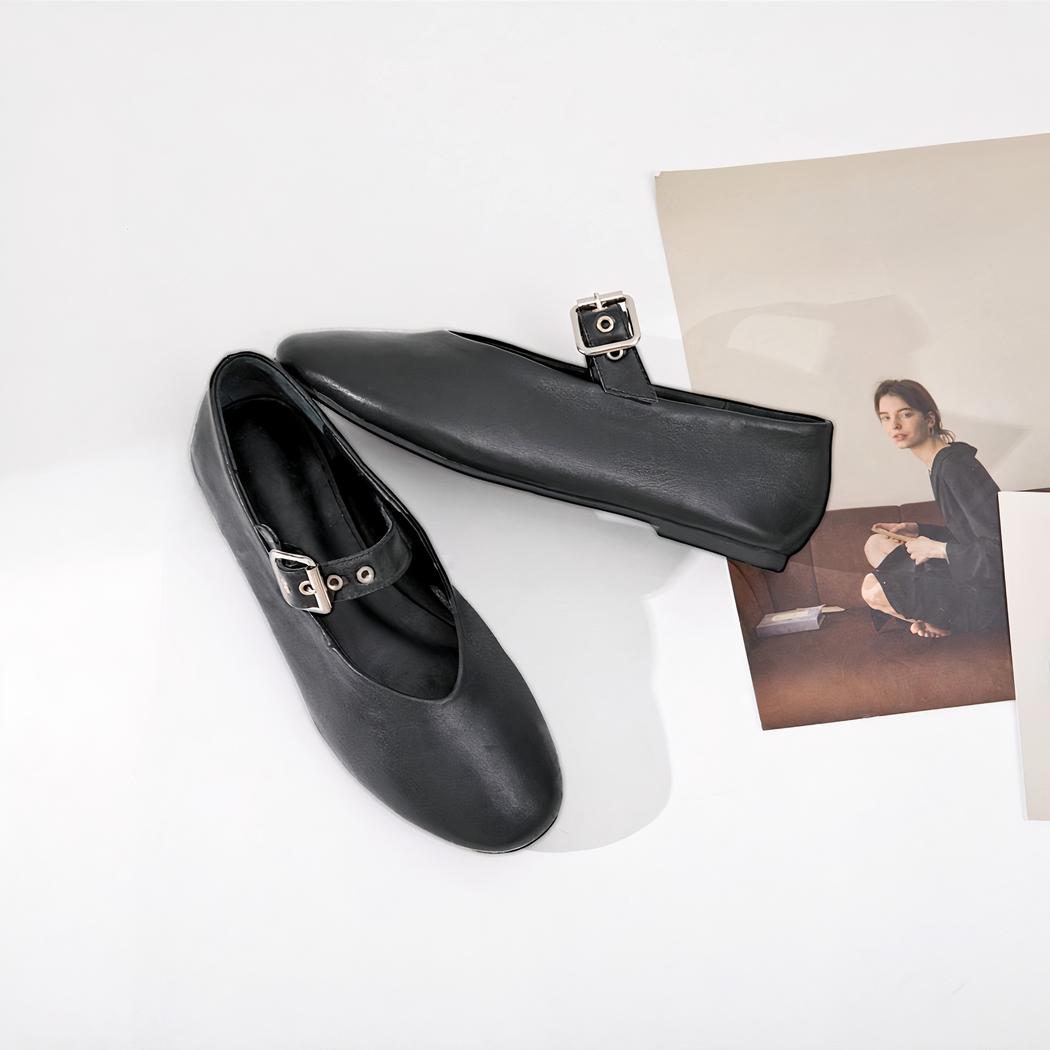Black rock style Mary Jane loafer with an adjustable buckle strap across the top of the foot.