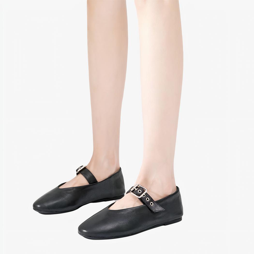 Black rock style Mary Jane loafer with an adjustable buckle strap across the top of the foot.