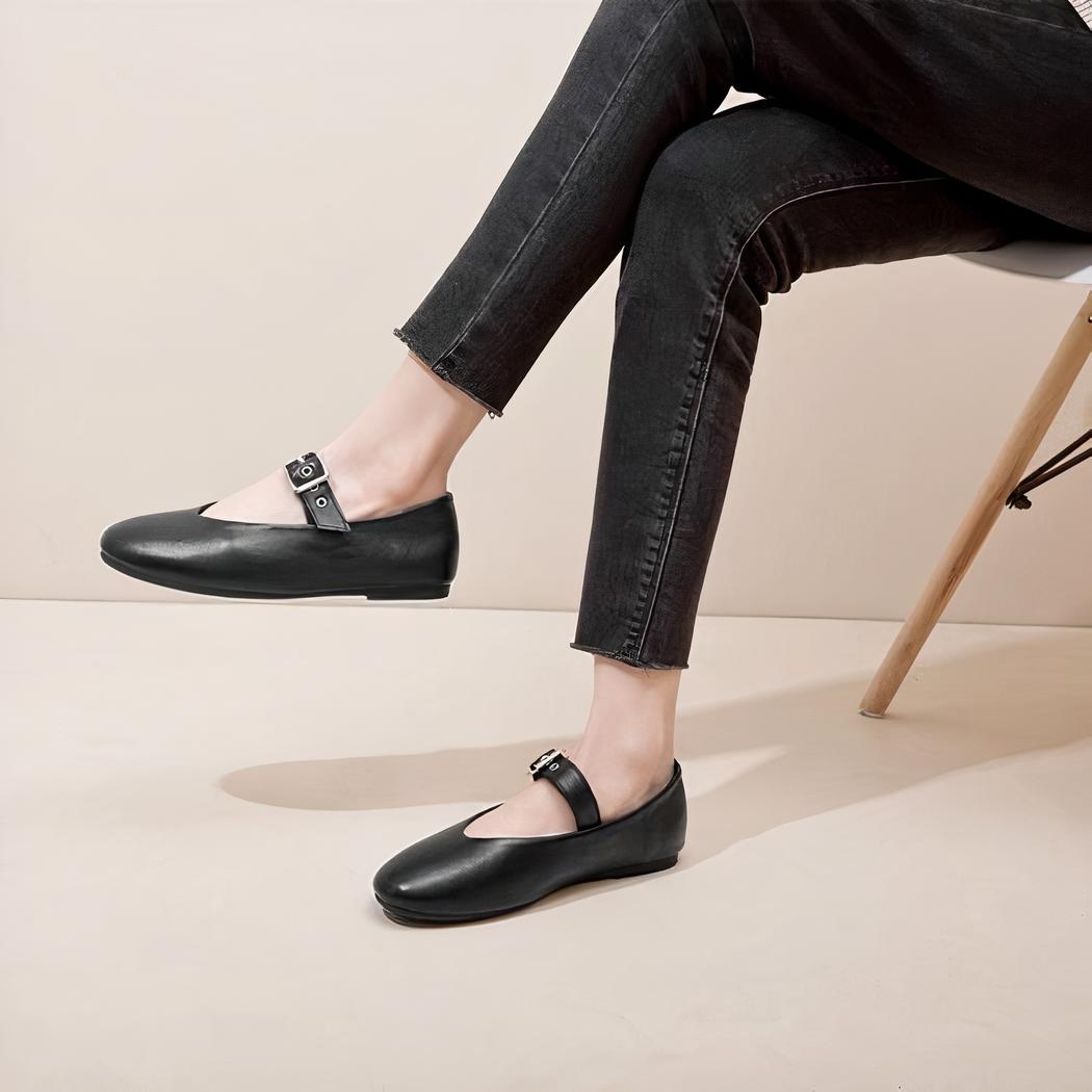 Black rock style Mary Jane loafer with an adjustable buckle strap across the top of the foot.