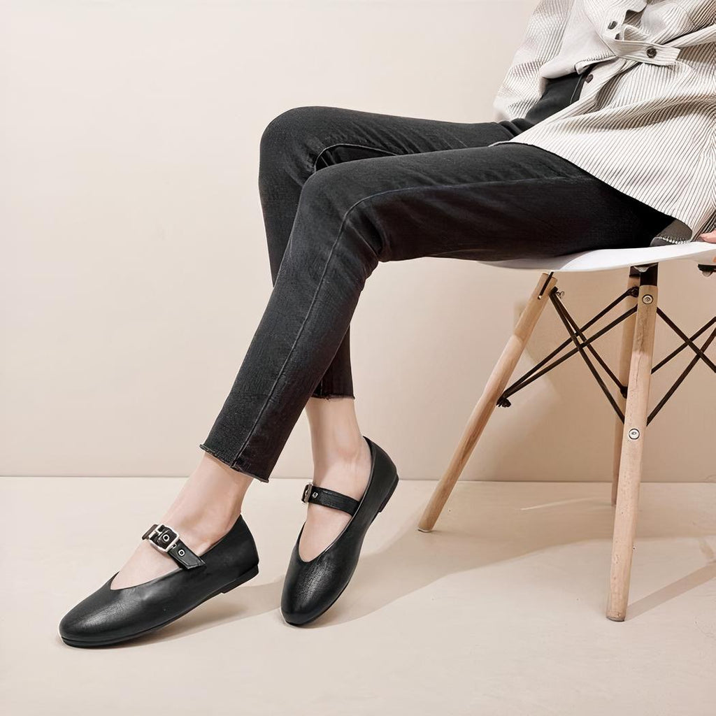 Black rock style Mary Jane loafer with an adjustable buckle strap across the top of the foot.