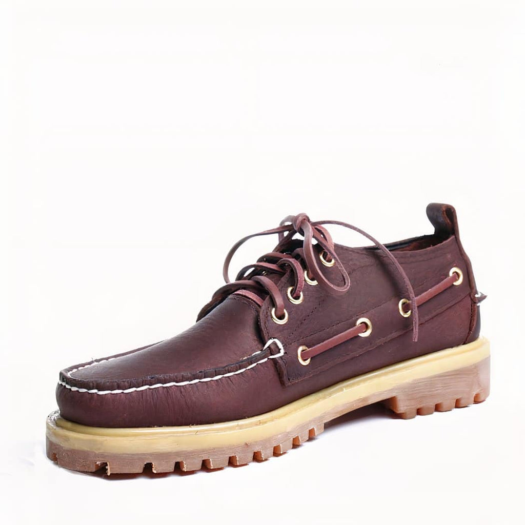 Photo of a brown boat loafer on a white background