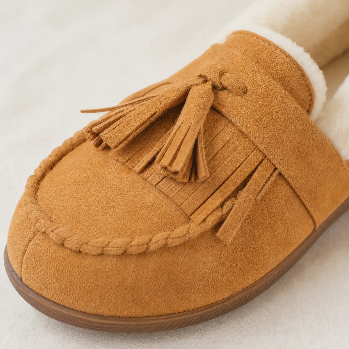 Camel faux suede moccasin with fringes and pom-poms Image