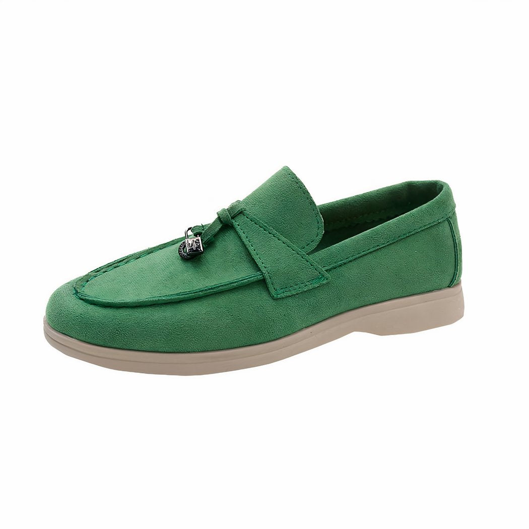 Loafer in green suede with a beige sole on a white background
