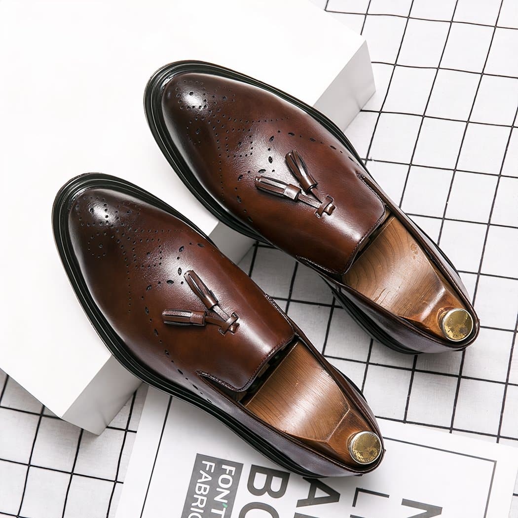 Brown loafers with tassel set on a white box and checkered floor