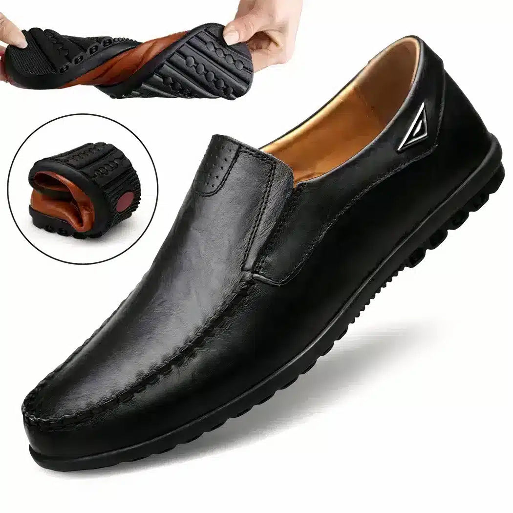 Black loafer on white background with vignette showing the flexibility of the sole.