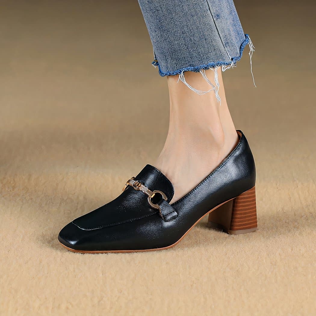 black leather loafer worn by a woman