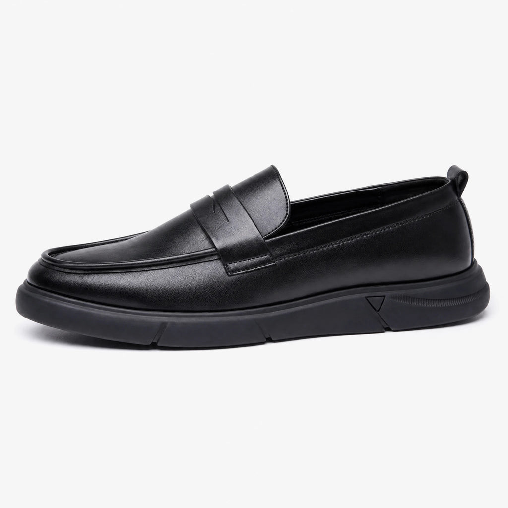 Men's black platform moccasins with decorative tab, side view
