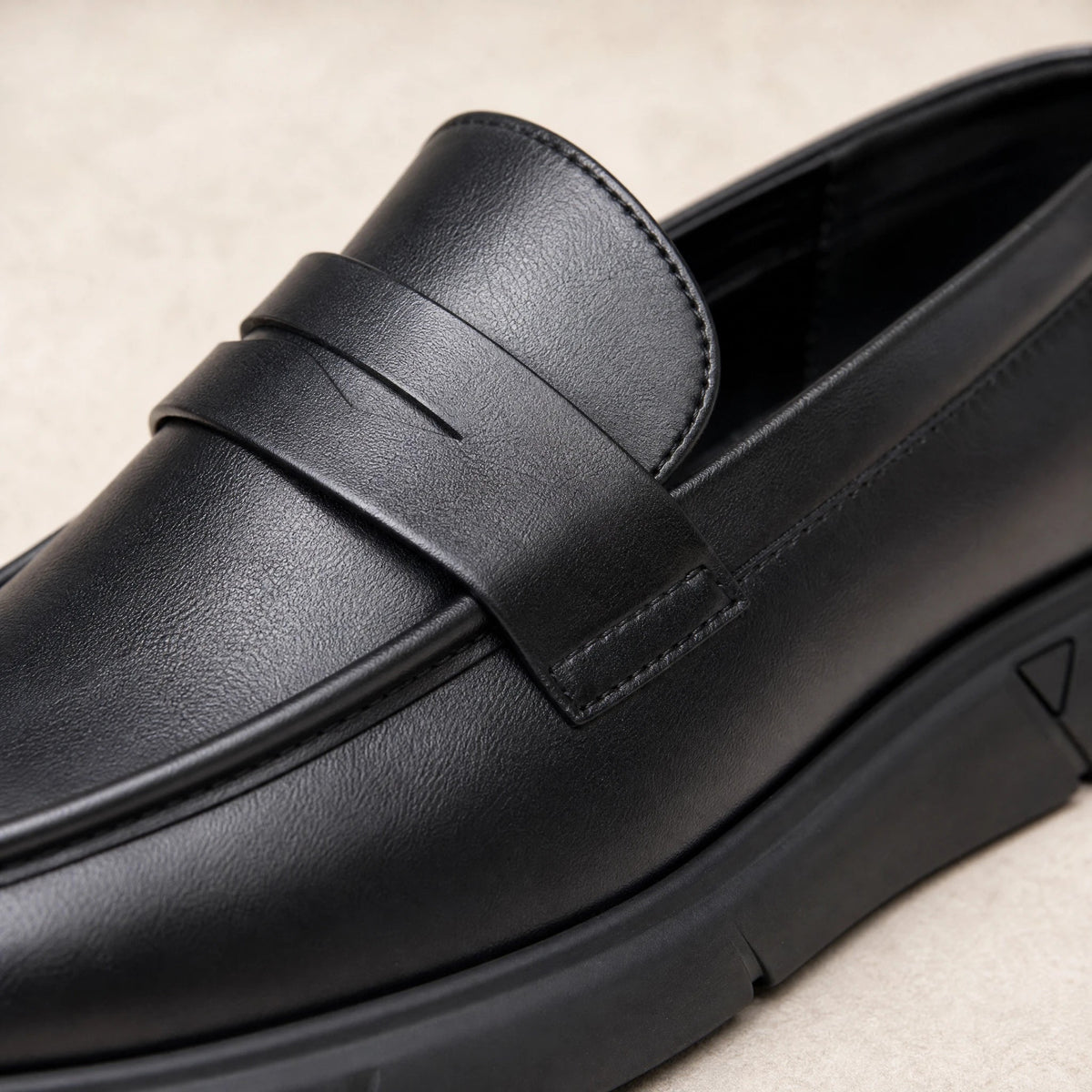 Black faux leather moccasin with decorative tab Image