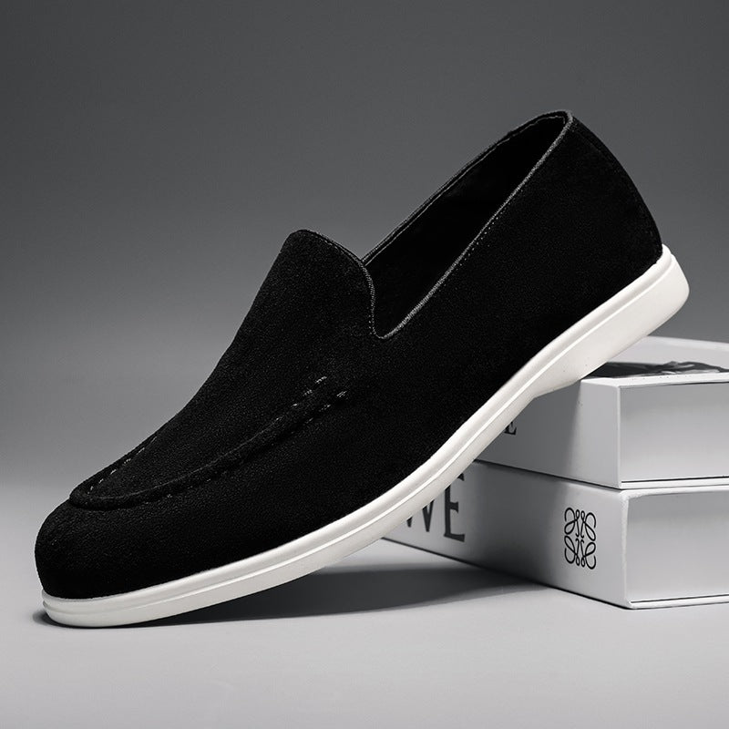 Men's black and beige slip-on loafer with white sole, black pair seen from above
