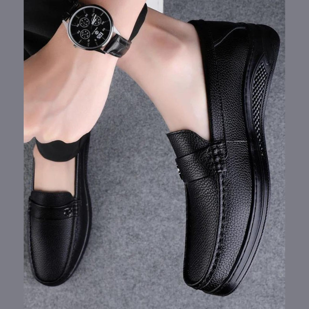 Men's black moccasins worn with chinos