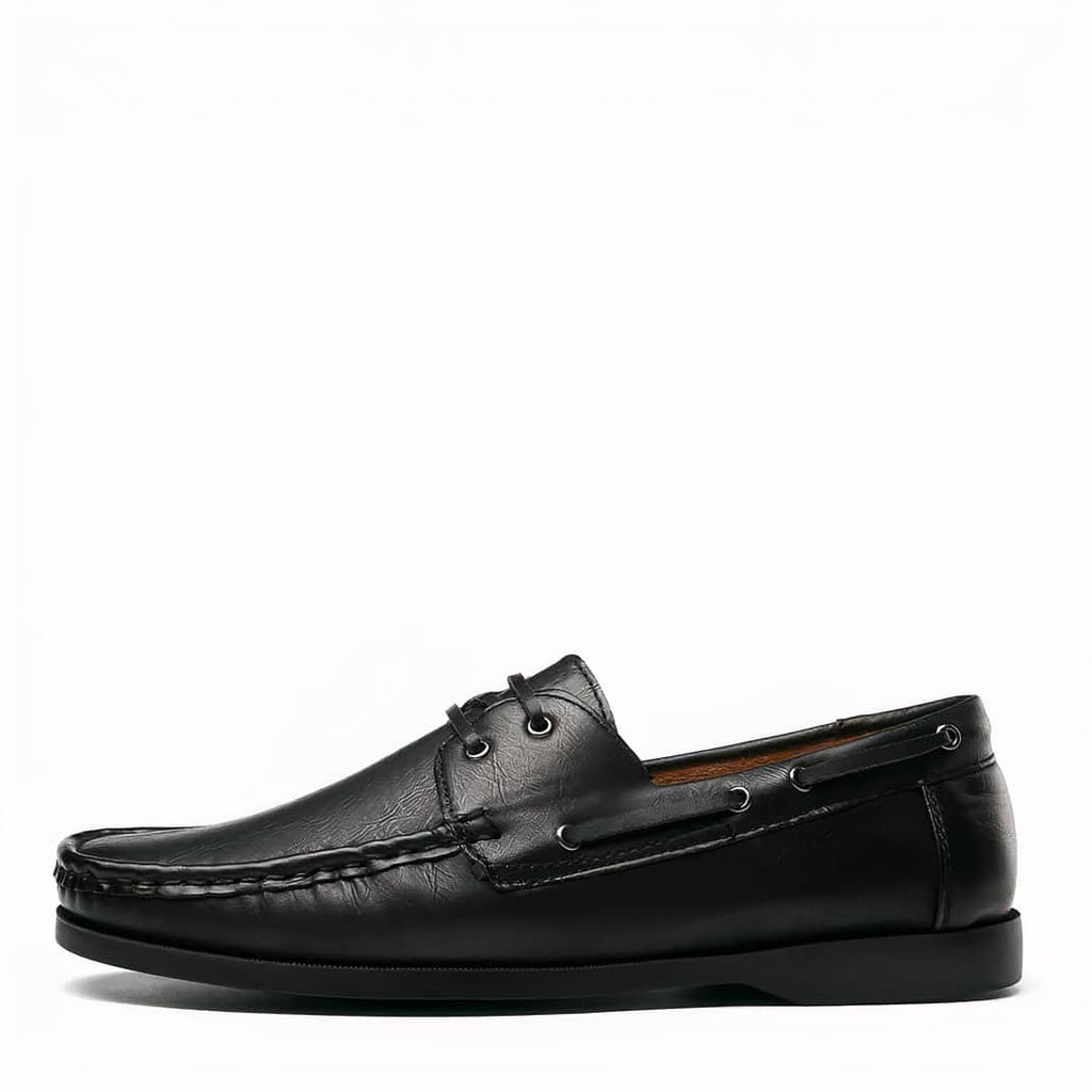 Photo of a black boat loafer on a white background