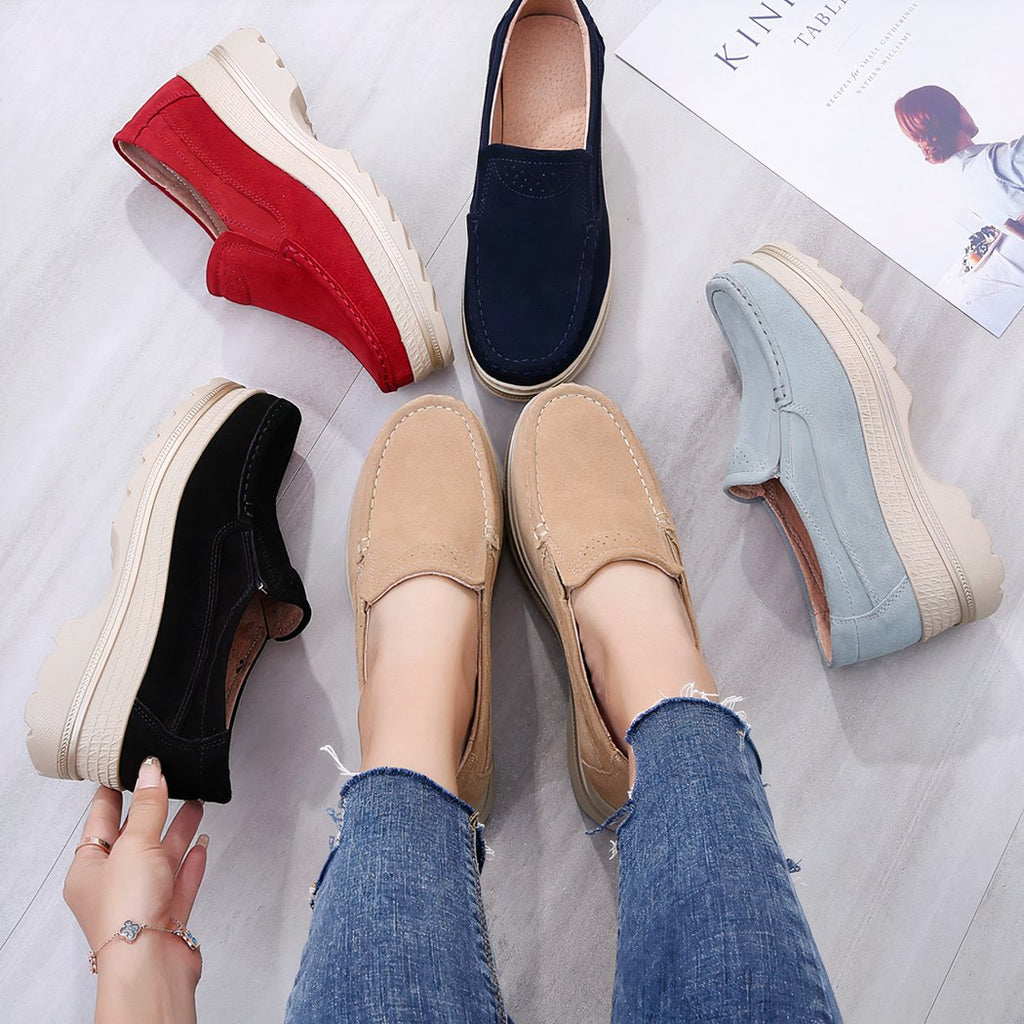 Photo of several orthopedic platform loafers in different colors, laid around a pair of worn beige loafers.