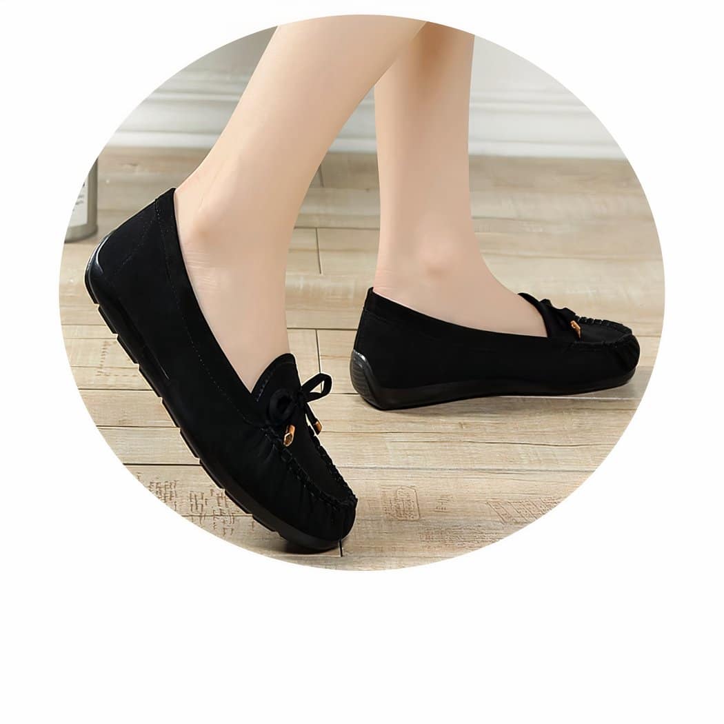 black suede loafer on women's feet