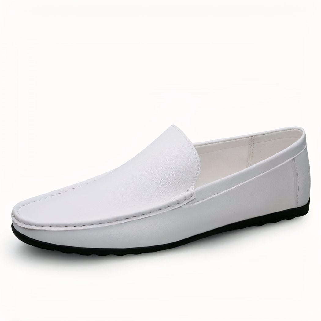 White leather loafer with black sole on white background