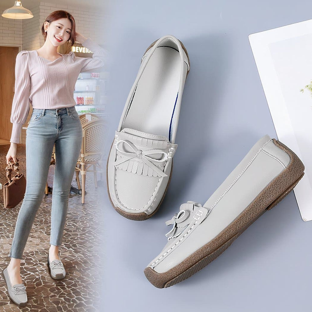 grey leather loafer worn by a woman