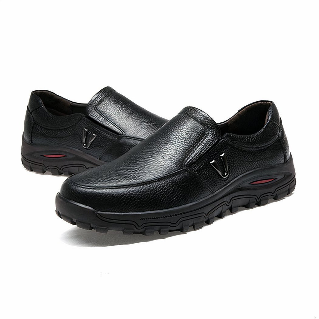 Photo of a pair of thick-soled black leather orthopedic loafers for men