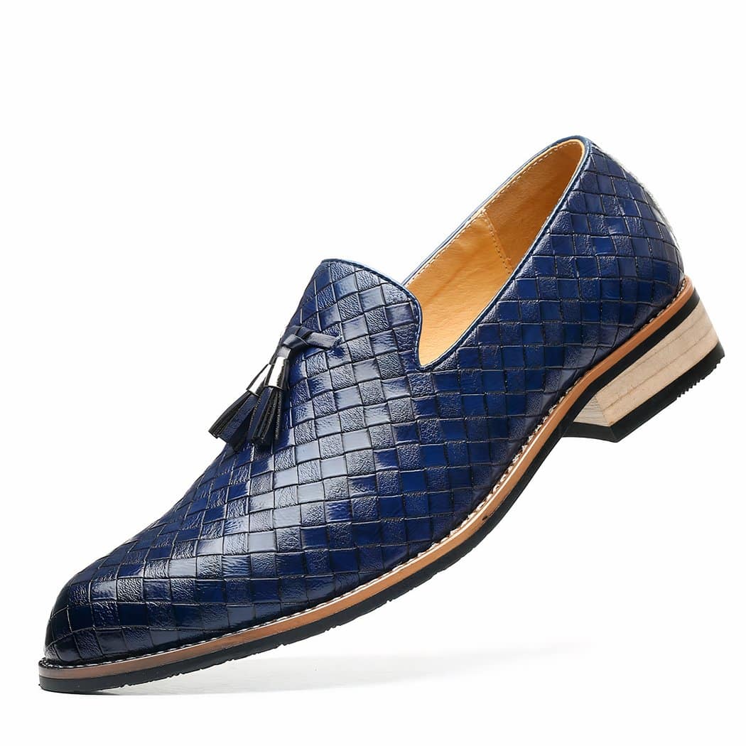 A blue braided leather loafer with light-colored sole and decorative tassels on a white background.