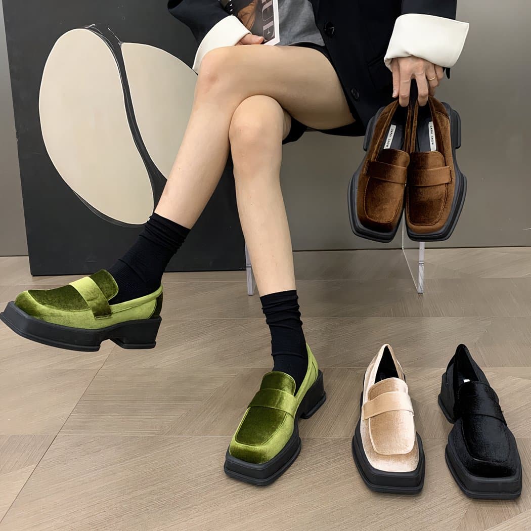 woman wearing velvet loafers