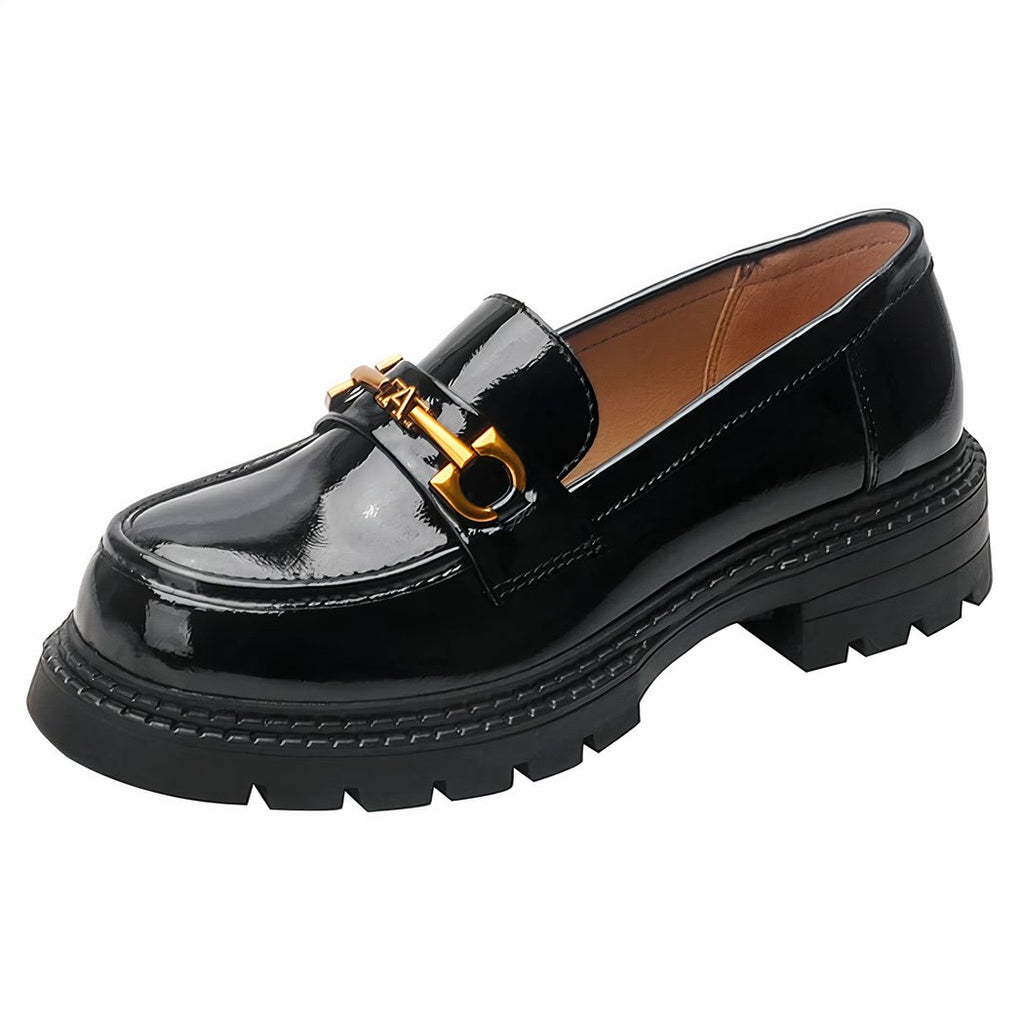 Photo of a black patent loafer on a white background