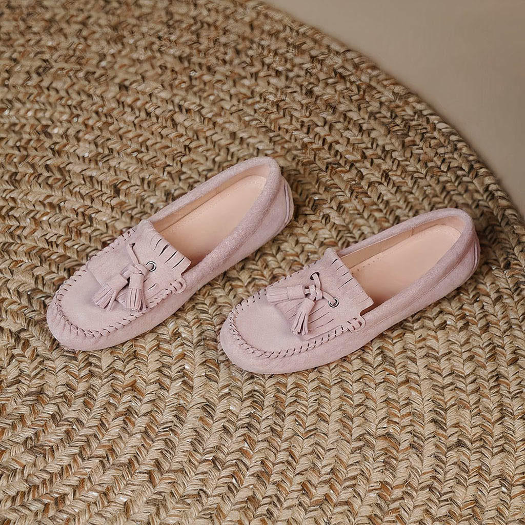 pair of pink fringed loafers