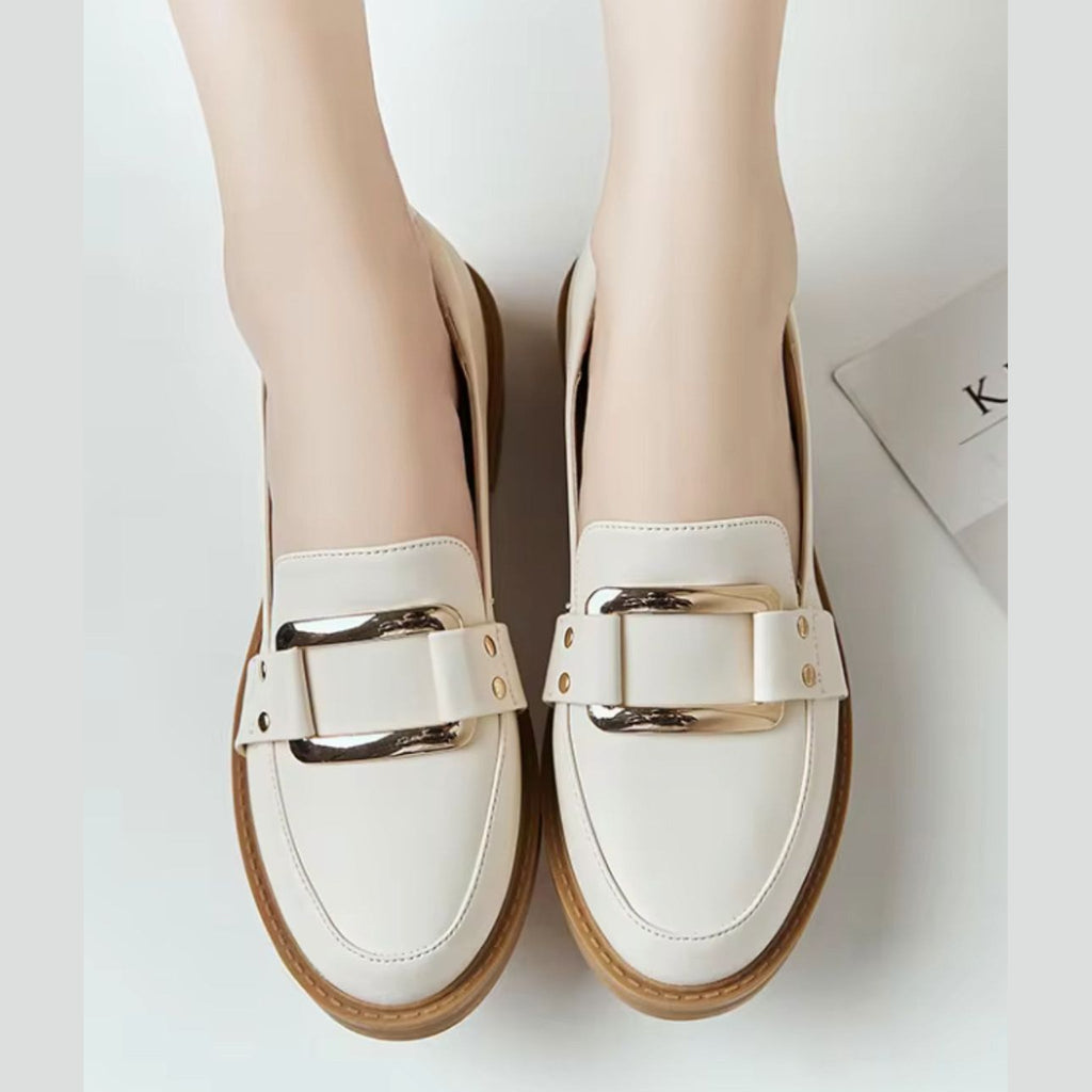 Beige moccasins worn with jeans