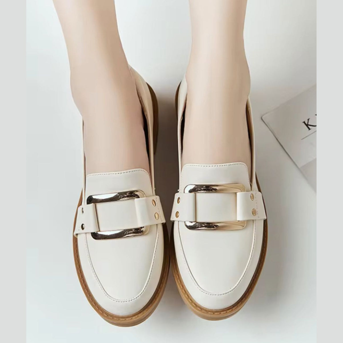 Beige moccasins worn with jeans
