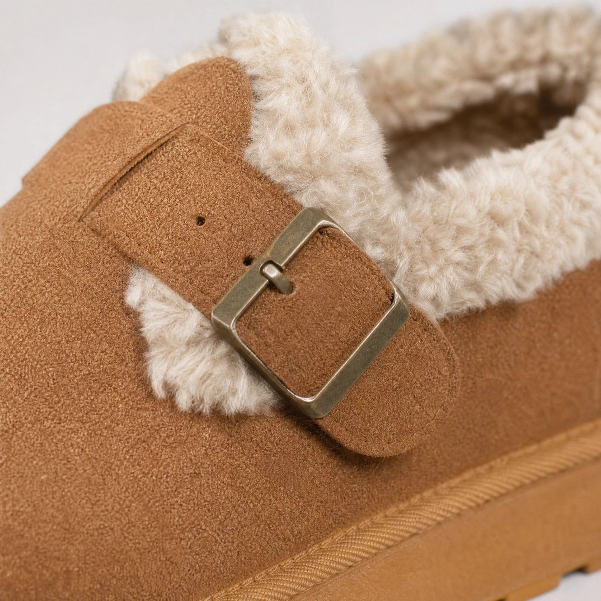 Brown fur-lined moccasins with white faux fur lining