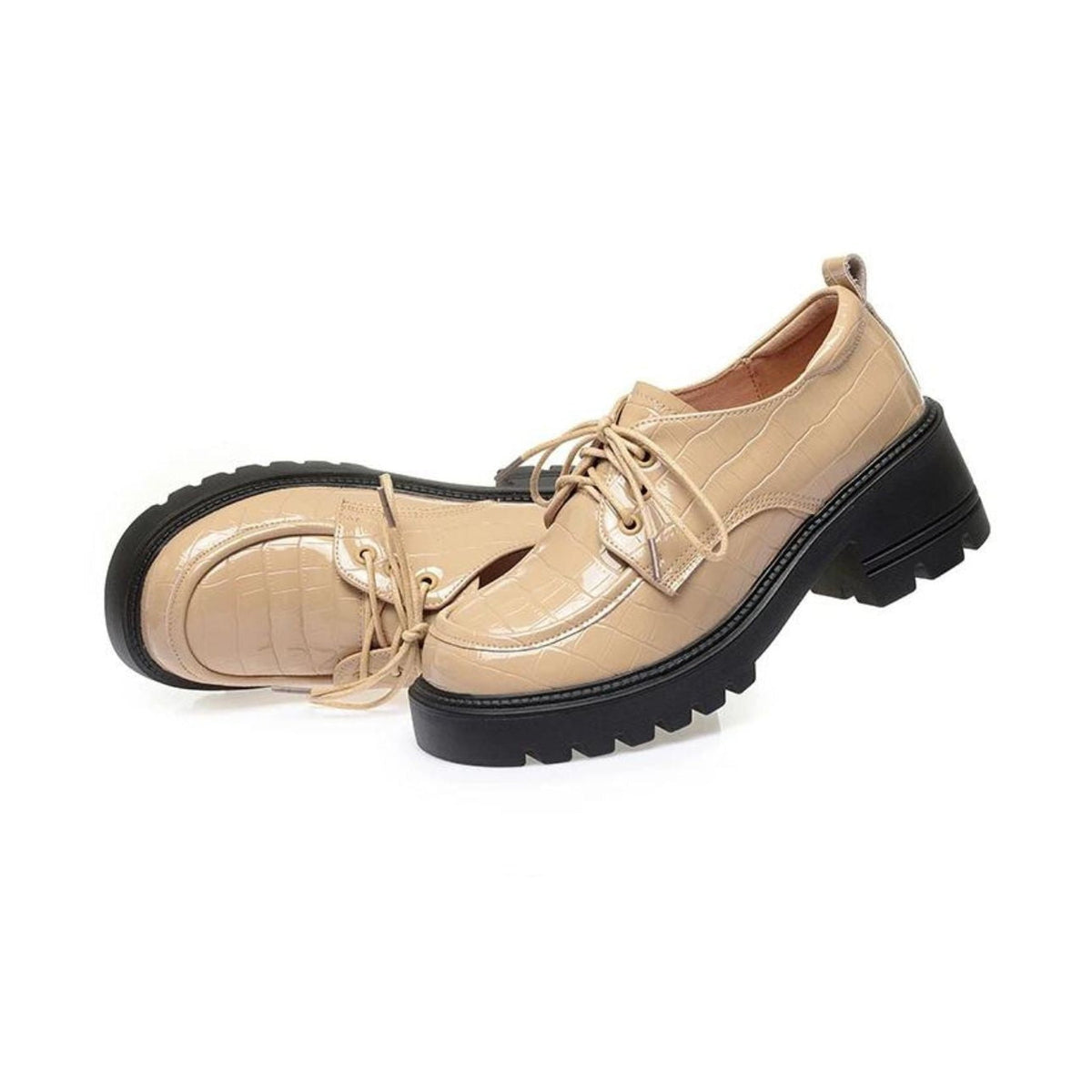 Beige patent croc-effect moccasins worn with jeans