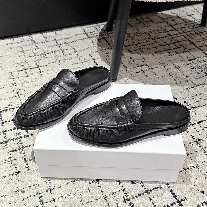 Women's leather penny loafer mule with flat heel in Black suede