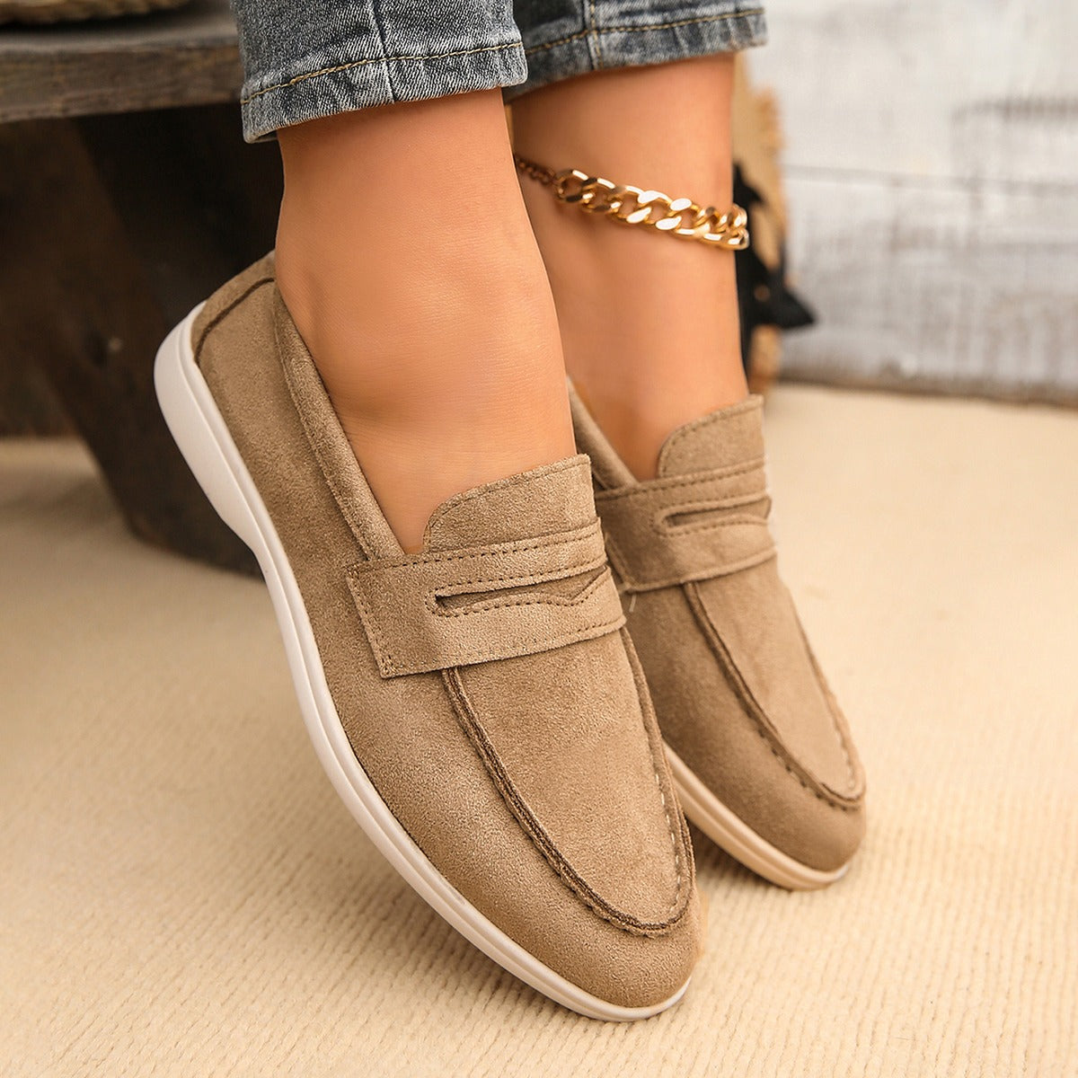 Women's strap loafer with white sole, black pair side by side