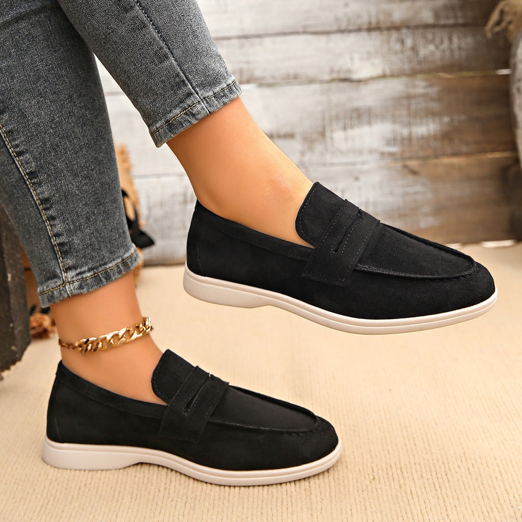 Women's strap loafer with white sole, navy styled with an outfit