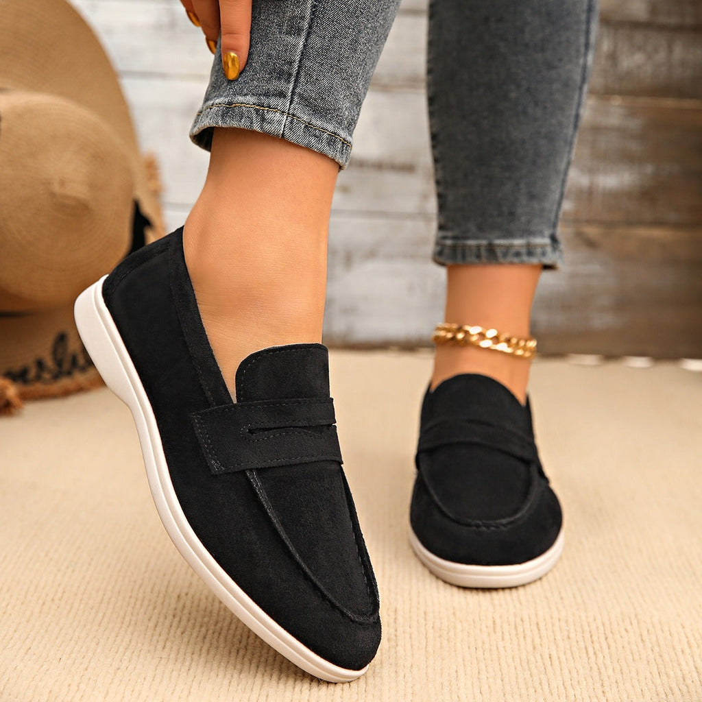 Women's strap loafer with white sole, black flat lay