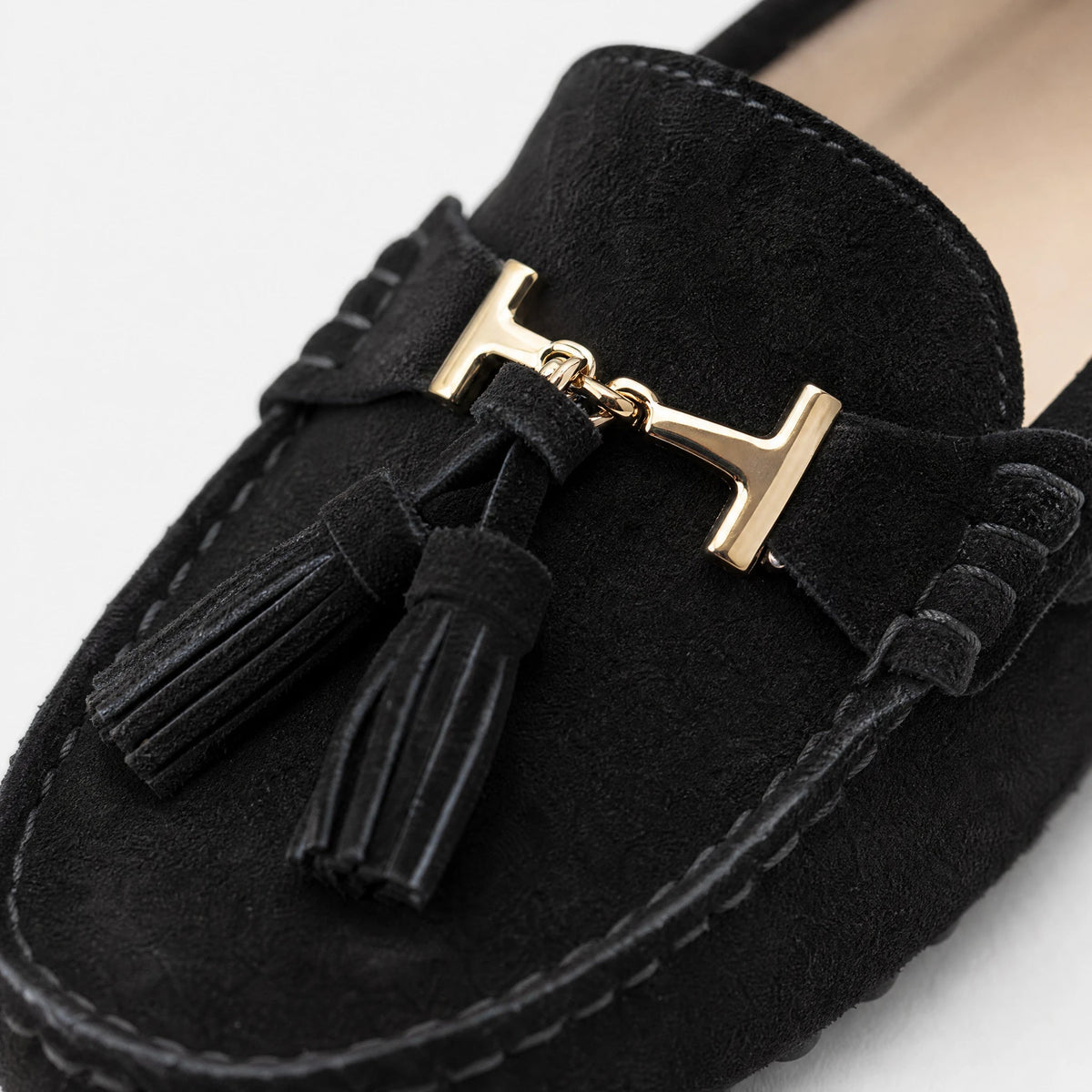 Women's leather tassel loafer with gold bit, navy side view