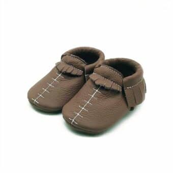 brown baby moccasin in leather with visible white stitching